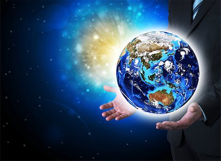 simsearch:400-07450042,k - Man in suit holding a earth in hand. The concept of globalization Photographie de stock - Aubaine LD & Abonnement, Code: 400-07413785