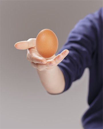 female teen hand presenting egg, selective focus Stock Photo - Budget Royalty-Free & Subscription, Code: 400-07413944