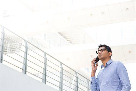 Young Asian Indian businessman on the phone, male business man, real modern office building as background. Stock Photo - Budget Royalty-Free & Subscription, Code: 400-07424752