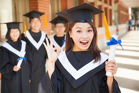 happy college graduate holding diploma  and make a gesture Stock Photo - Budget Royalty-Free & Subscription, Code: 400-07425875