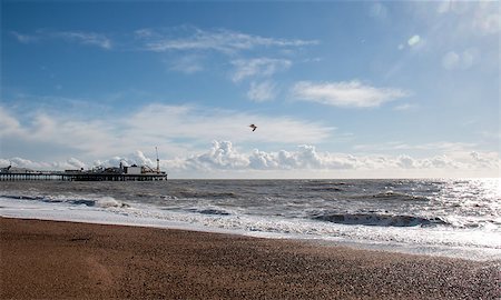 Brighton Pier on the Sussex coast, England, with sunshine, sea and clouds. Foto de stock - Royalty-Free Super Valor e Assinatura, Número: 400-07425995