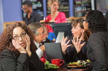 Bored woman with coworkers at lunch break Stock Photo - Budget Royalty-Free & Subscription, Code: 400-07426193