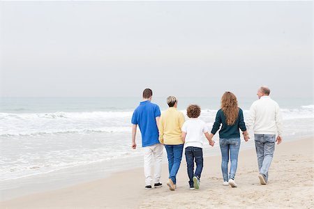 Rear view image of beautiful family walking on beach Stock Photo - Budget Royalty-Free & Subscription, Code: 400-07426229