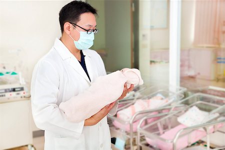 doctor holding a newborn baby in a baby room Stock Photo - Budget Royalty-Free & Subscription, Code: 400-07427443