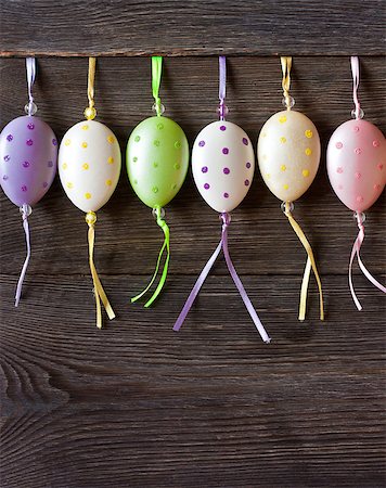 simsearch:400-07422530,k - Colorful Easter eggs hanging on wooden background with copy space for text. Fotografie stock - Microstock e Abbonamento, Codice: 400-07427492