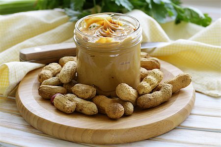 homemade peanut butter with whole nuts on a wooden table Stock Photo - Budget Royalty-Free & Subscription, Code: 400-07427867