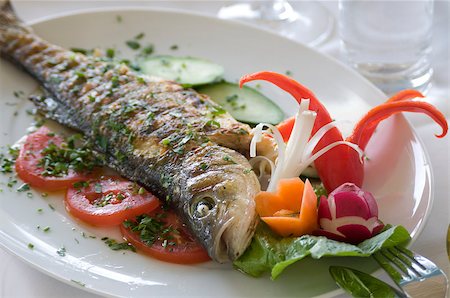 This is close-up picture of stuffed sea bass with vegetables. This is a dish of Mediterranean cooking. Stock Photo - Budget Royalty-Free & Subscription, Code: 400-07428083