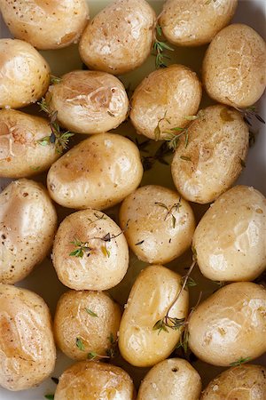 Roasted baby potatoes with thyme, olive oil and salt on baking sheet Stock Photo - Budget Royalty-Free & Subscription, Code: 400-07428144