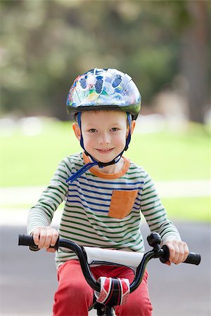 cute smiling boy in helmet riding a bike Stock Photo - Budget Royalty-Free & Subscription, Code: 400-07428175