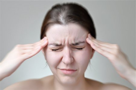 A young woman holding her painful head Stock Photo - Budget Royalty-Free & Subscription, Code: 400-07428211