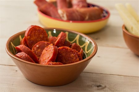 Tapas, chorizo, and cured ham on a wooden table Stock Photo - Budget Royalty-Free & Subscription, Code: 400-07428395