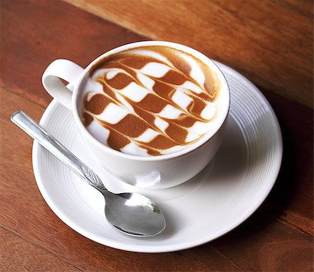 simsearch:824-07562793,k - Cup of latte coffee on the wooden desk Photographie de stock - Aubaine LD & Abonnement, Code: 400-07429850