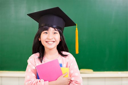 smiling girl wear a graduation hat and holding books Stock Photo - Budget Royalty-Free & Subscription, Code: 400-07429877