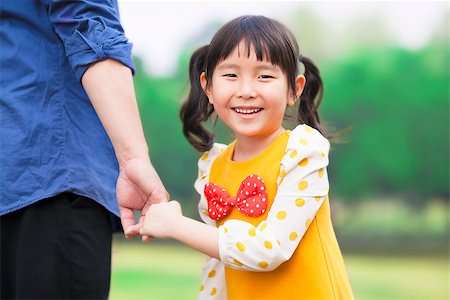 family relaxing with kids in the sun - pretty girl hold father hand in the park Stock Photo - Budget Royalty-Free & Subscription, Code: 400-07429896