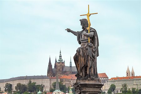 simsearch:400-04759426,k - St. John the Baptist, is shown as a preacher with a golden cross and a font from a shell on his side.  Sculpted by Josef Max in 1857 in the Charles Bridge, Prague, Czech Republic Stock Photo - Budget Royalty-Free & Subscription, Code: 400-07420231
