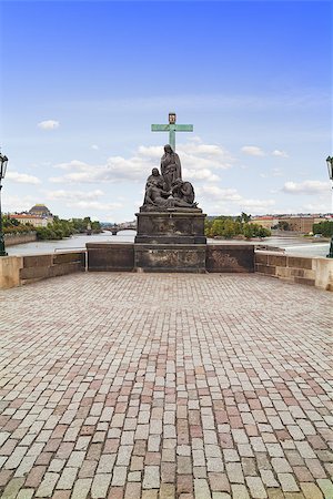 simsearch:400-05680683,k - Statue of Pieta in the Charles Bridge in Prague, Czech Republic. The group represents the Virgin Mary and St. Magdalene bemoaning the dead Christ, above whom stands St. John the EvangeliSt. Stock Photo - Budget Royalty-Free & Subscription, Code: 400-07420242