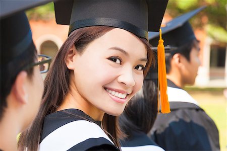 smiling woman standing out from a graduation group Stock Photo - Budget Royalty-Free & Subscription, Code: 400-07421066