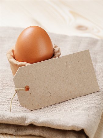 brown egg in handmade holder, on rustic table Stock Photo - Budget Royalty-Free & Subscription, Code: 400-07421364