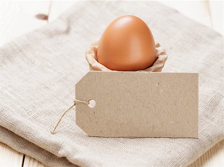brown egg in handmade holder, on rustic table Stock Photo - Budget Royalty-Free & Subscription, Code: 400-07421363