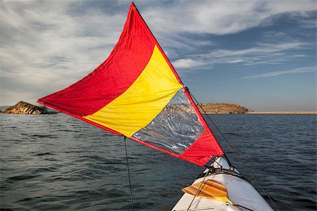 red canoe on lake - canoe bow with a downwind sail  on Horsetooth Reservoir in Colorado near Fort Collins Stock Photo - Budget Royalty-Free & Subscription, Code: 400-07422788