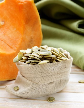 simsearch:400-06954534,k - peeled pumpkin seeds and fresh pumpkin on a wooden table Stock Photo - Budget Royalty-Free & Subscription, Code: 400-07422973