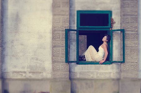 Beautiful girl standing on an open window in an old castle Stock Photo - Budget Royalty-Free & Subscription, Code: 400-07423258