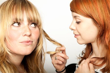 two beautiful girls looking at blond and red hair Stock Photo - Budget Royalty-Free & Subscription, Code: 400-07423553