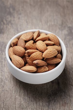 white bowl full of almonds, on wooden table Stock Photo - Budget Royalty-Free & Subscription, Code: 400-07430247