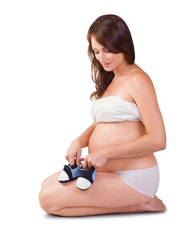 simsearch:400-04205919,k - pregnant woman with small shoes for the unborn baby isolated on white background Stock Photo - Budget Royalty-Free & Subscription, Code: 400-07430844