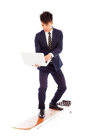 surfers men model - businessman using a laptop on a  surfboard Stock Photo - Budget Royalty-Free & Subscription, Code: 400-07431089