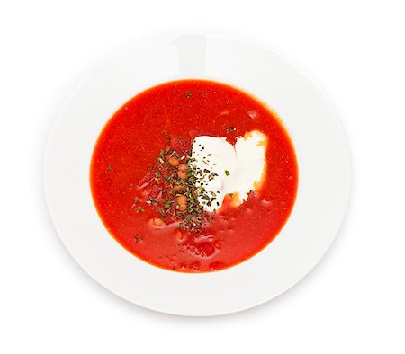 simsearch:400-07301312,k - Ukrainian and russian national red borsch with sour cream and herbs closeup. Isolated on white background. Top view. Stockbilder - Microstock & Abonnement, Bildnummer: 400-07445505