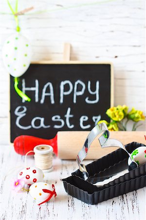 Easter cooking. Bunny cookie cutter, rolling pin and colorful chocolate eggs. Stock Photo - Budget Royalty-Free & Subscription, Code: 400-07445517