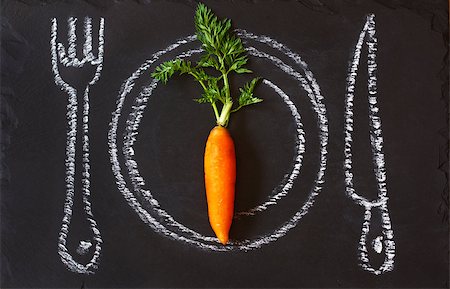 Healthy food concept. Fresh organic carrot on a chalk painted plate. Photographie de stock - Aubaine LD & Abonnement, Code: 400-07445522