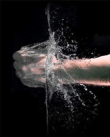 simsearch:400-04790437,k - Fist punch into water with big splashes, on a black background Stock Photo - Budget Royalty-Free & Subscription, Code: 400-07445920