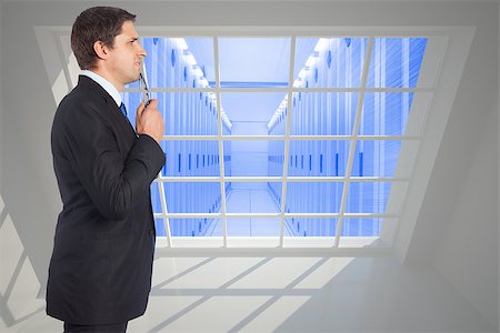 simsearch:400-07277781,k - Thinking businessman holding glasses against server hallway seen through window Stock Photo - Budget Royalty-Free & Subscription, Code: 400-07446547