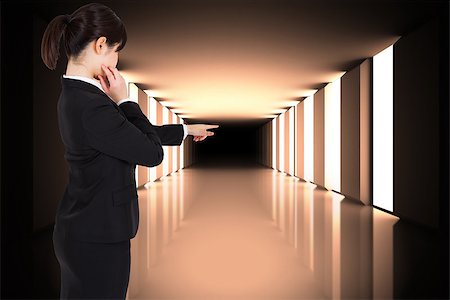 simsearch:614-06044031,k - Thoughtful businesswoman pointing against lit up black modern hallway Foto de stock - Super Valor sin royalties y Suscripción, Código: 400-07446621