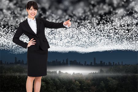 pointing horizon - Smiling businesswoman pointing against bright stars of energy over landscape Stock Photo - Budget Royalty-Free & Subscription, Code: 400-07446748