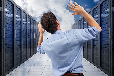 simsearch:400-07448129,k - Businessman posing with arms raised against server hallway in the sky Stock Photo - Budget Royalty-Free & Subscription, Code: 400-07446742