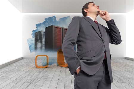 simsearch:400-07447273,k - Thoughtful businessman with hand on chin against abstract screen in room showing server towers Stock Photo - Budget Royalty-Free & Subscription, Code: 400-07446855