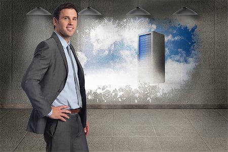 simsearch:400-07448129,k - Smiling businessman with hand on hip against splash on wall revealing server tower Foto de stock - Royalty-Free Super Valor e Assinatura, Número: 400-07446950