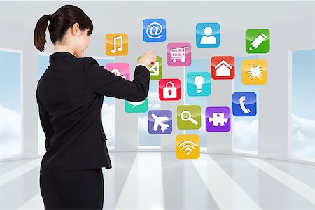 simsearch:400-07277726,k - Businesswoman pointing against computing application icons Stock Photo - Budget Royalty-Free & Subscription, Code: 400-07447099