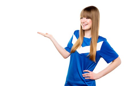 person playing soccer standing back - Happy girl in football blue shirt is presenting something, isolated on white background Stock Photo - Budget Royalty-Free & Subscription, Code: 400-07447242