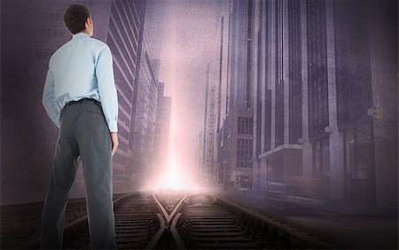 simsearch:400-07446838,k - Businessman standing with hand in pockets against cityscape projection over train tracks Photographie de stock - Aubaine LD & Abonnement, Code: 400-07447283