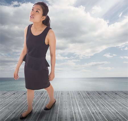 Asian businesswoman walking against bridge over water and blue sky Stock Photo - Budget Royalty-Free & Subscription, Code: 400-07447393