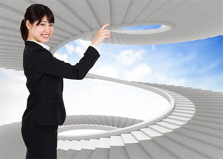 person on winding stairs - Smiling businesswoman pointing against spiral staircase in the sky Stock Photo - Budget Royalty-Free & Subscription, Code: 400-07447439