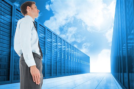 simsearch:400-07448129,k - Serious businessman standing against server hallway in the blue sky Stock Photo - Budget Royalty-Free & Subscription, Code: 400-07447594