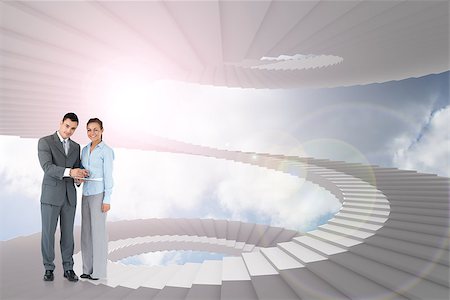 person on winding stairs - Business partners with clipboard against winding staircase in the sky Stock Photo - Budget Royalty-Free & Subscription, Code: 400-07448198