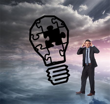 Stressed businessman with hands on head against light bulb graphic on colourful horizon Stock Photo - Budget Royalty-Free & Subscription, Code: 400-07448207