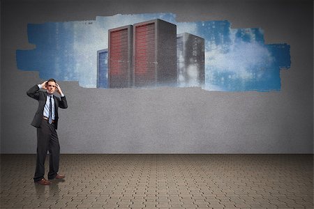 simsearch:400-07447273,k - Stressed businessman with hands on head against display on wall showing server towers Stock Photo - Budget Royalty-Free & Subscription, Code: 400-07448581