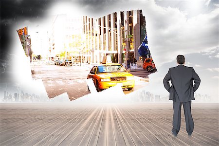 person standing back building street - Businessman standing back to the camera with hands on hip  against screen showing city street Stock Photo - Budget Royalty-Free & Subscription, Code: 400-07448665